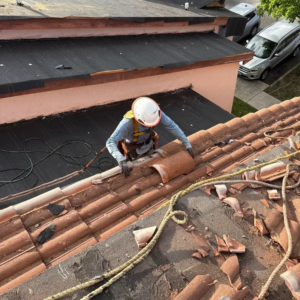 SCI Roofing technician installing clay barrel tile on a South Florida home