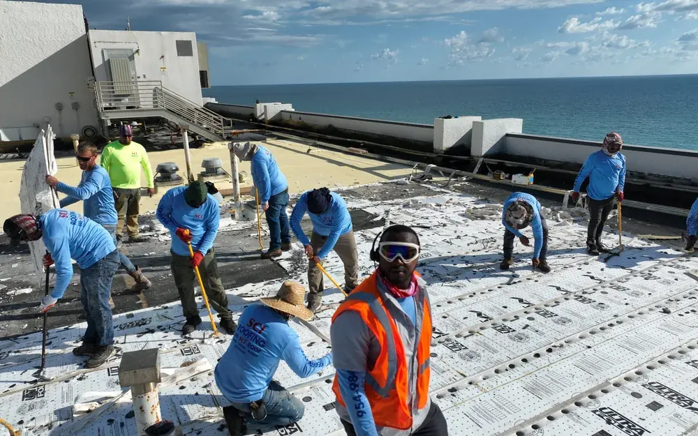 SCI Roofing crew installing a commercial roofing system on an oceanfront South Florida building