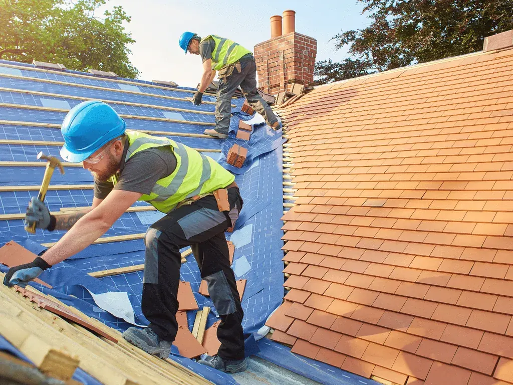 SCI Roofing crew installing underlayment and barrel tile on a South Florida home
