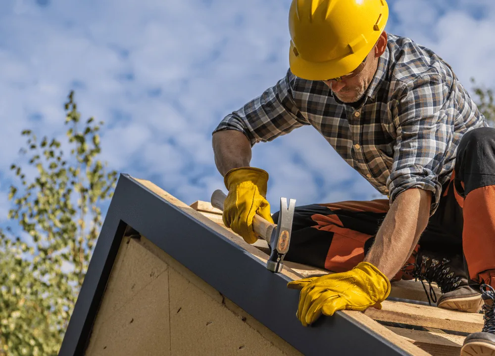 SCI Roofing craftsman installing shingles along a roof ridge in South Florida